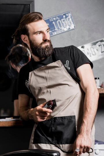 portrait-barber-with-electric-trimmer_23-2147839771